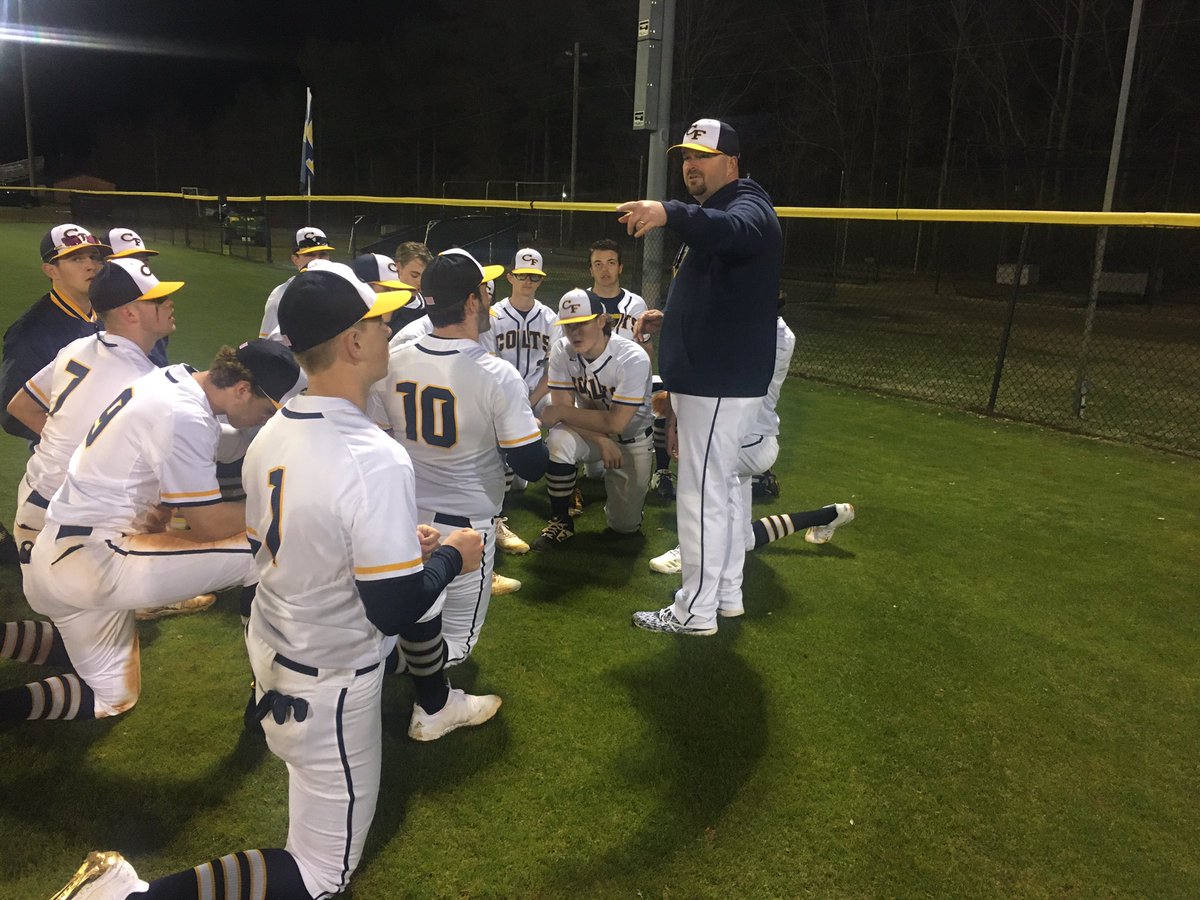 Cape Fear Colts baseball team huddles together on the field